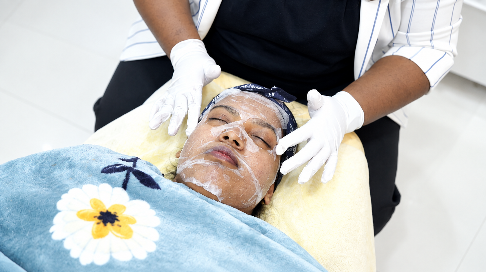 Chemical peel solution being applied to a patient's face during treatment at PRALASH Dermystique & Dentique.