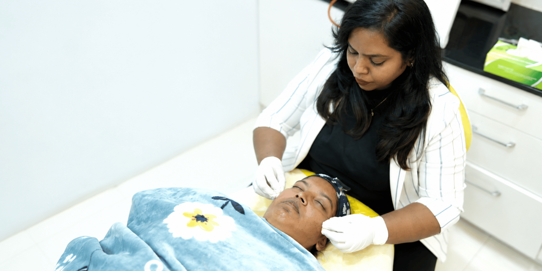 Dr. Premalatha performing a chemical peel treatment at PRALASH Dermystique & Dentique.